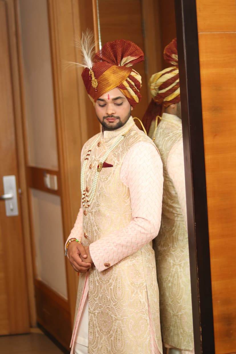 Groom reflected in mirror during wedding preparation